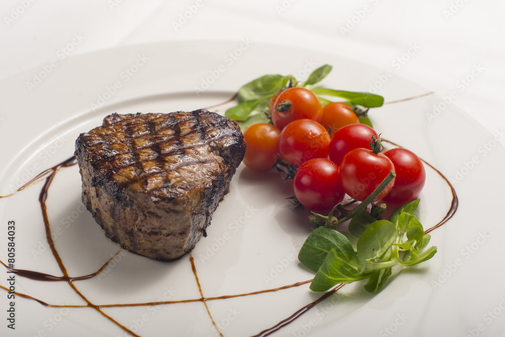 Grilled sirloin steak with tomatoes.