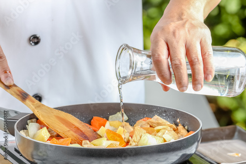 chef pouring  oil