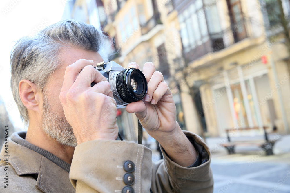 Photographer taking pictures in city street Photographer taking pictures in city street
