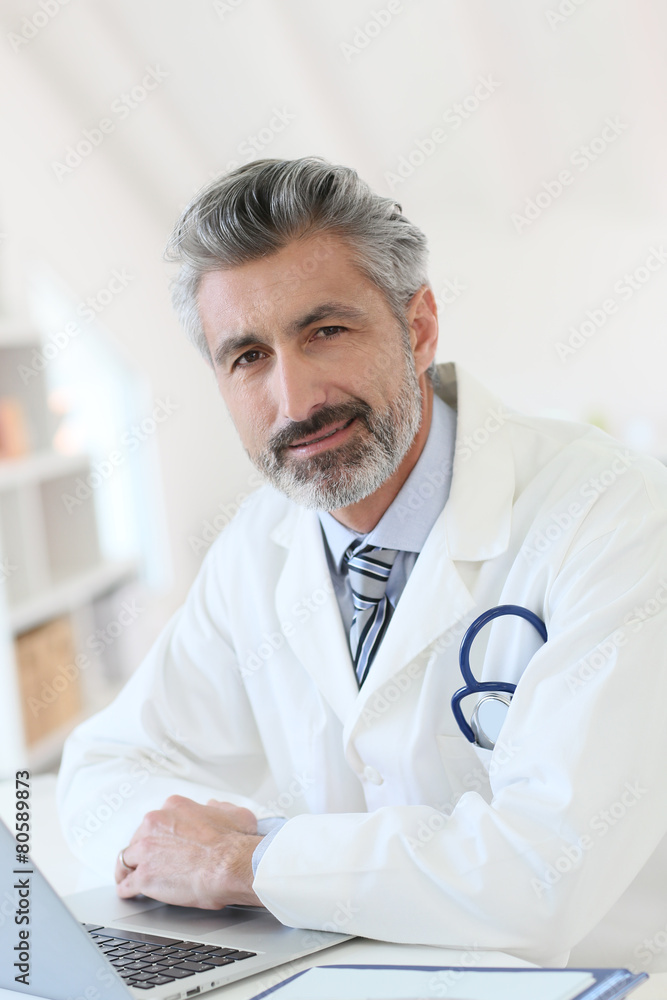 Doctor working in office on laptop Doctor working in office on laptop