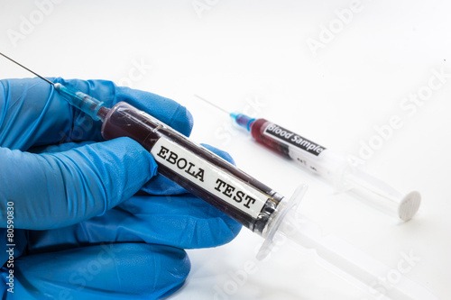 doctor with syringe with blood infected with ebola virus