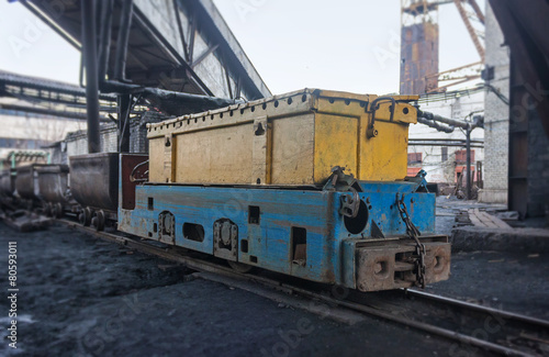 Train in national colors with trolleys in a coal mine. Donbass,