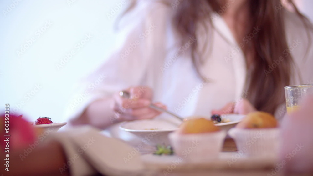 Woman eating cereal with berries for breakfast