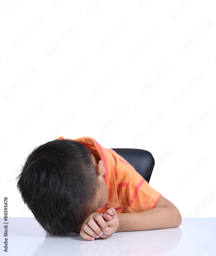 Little boy boring homework and sleeping on white table Little boy boring homework and sleeping on white table