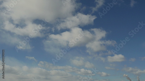 Timelapse floating clouds on a blue sky over the city 4K