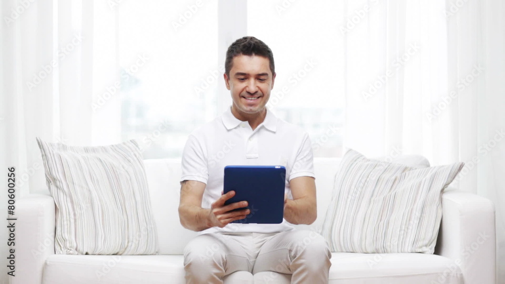smiling man working with tablet pc at home smiling man working with tablet pc at home
