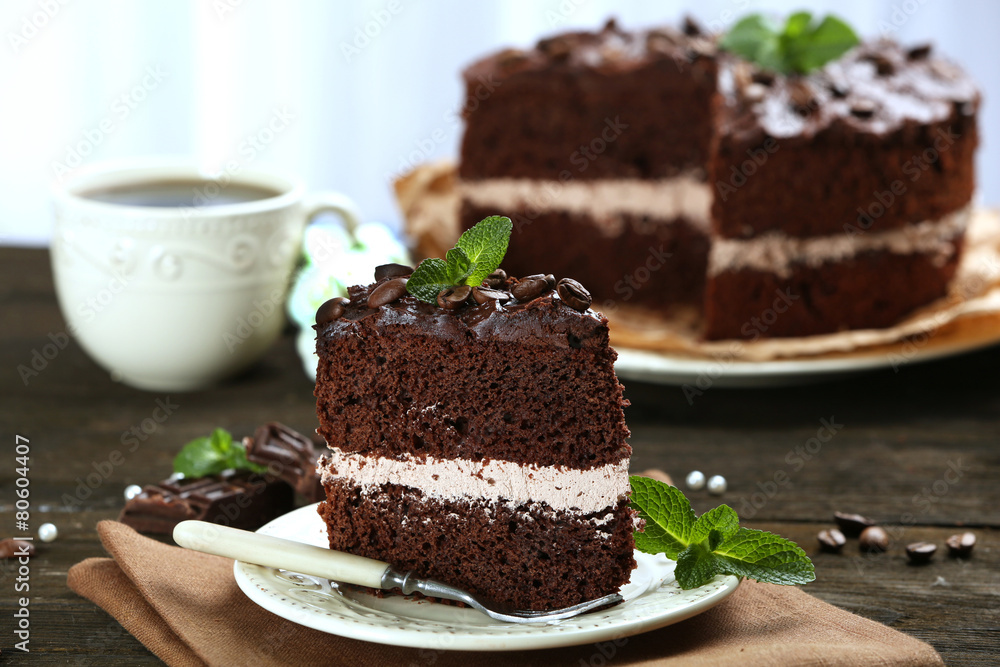 Delicious chocolate cake on table on light background Delicious chocolate cake on table on light background