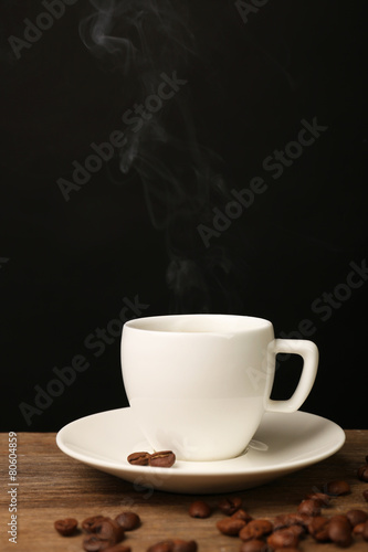 Cup of hot coffee with saucer