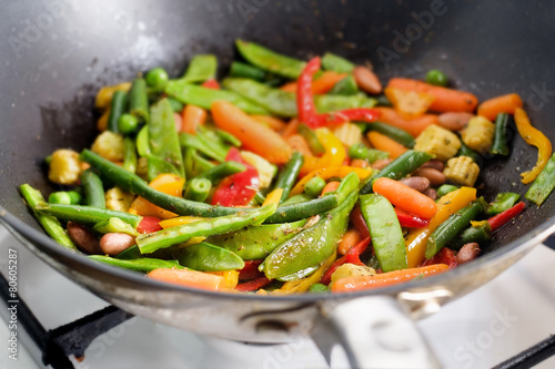 Closeup roasting mexican vegetables mix in wok photo