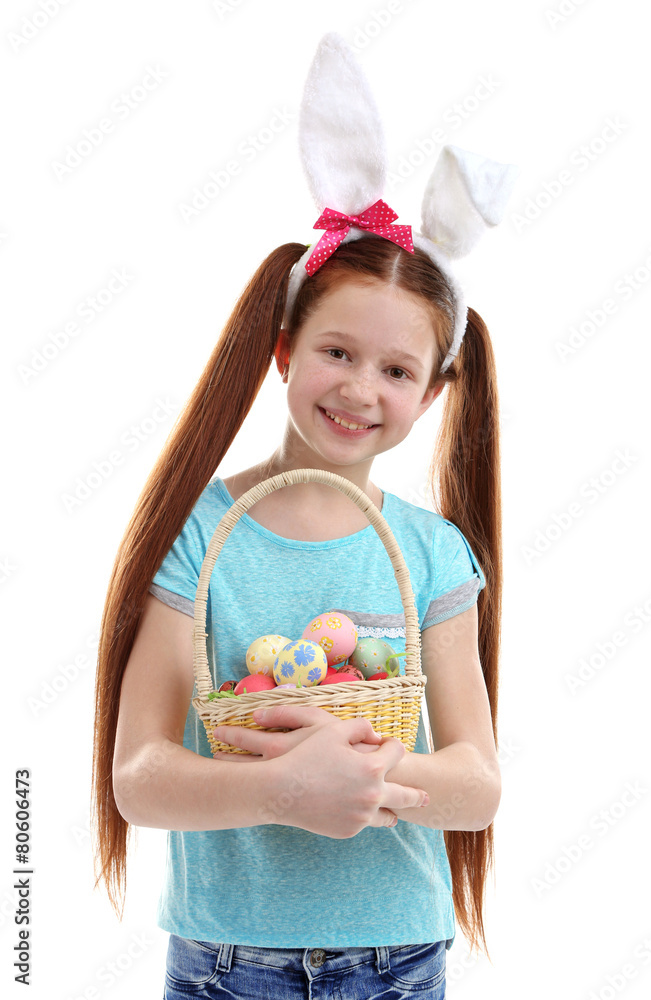 Beautiful little girl wearing Easter bunny ears and holding wicker basket with Easter eggs, isolated on white Beautiful little girl wearing Easter bunny ears and holding wicker basket with Easter eggs, isolated on white