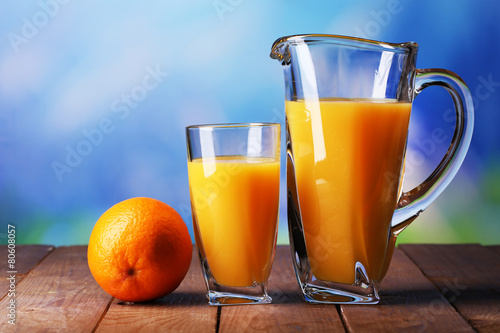 Glass and pitcher of orange juice