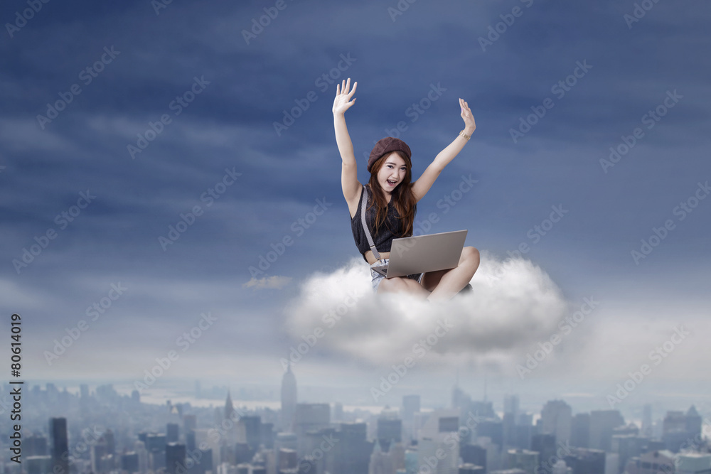 Successful brunette girl with laptop on cloud