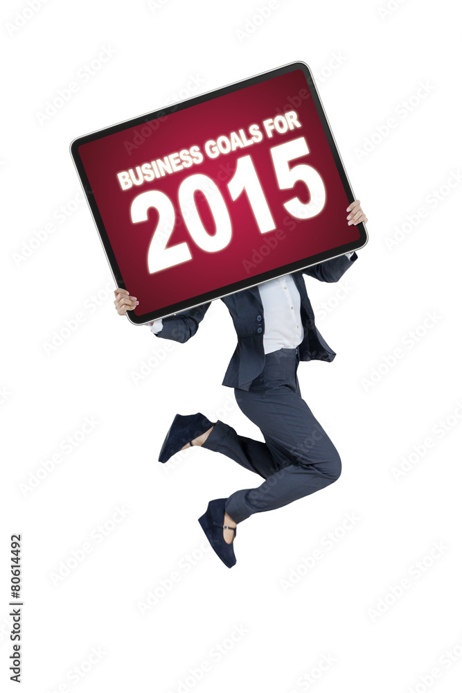 Worker with a board of business goals for 2015 Worker with a board of business goals for 2015