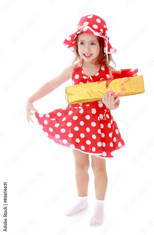 Girl in summer red polka dot dress holding a gift Girl in summer red polka dot dress holding a gift