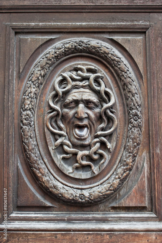 Medusa head carving on a door