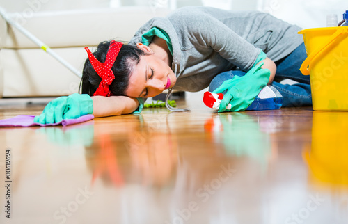 Housewife tired of cleaning sleeping on the floor