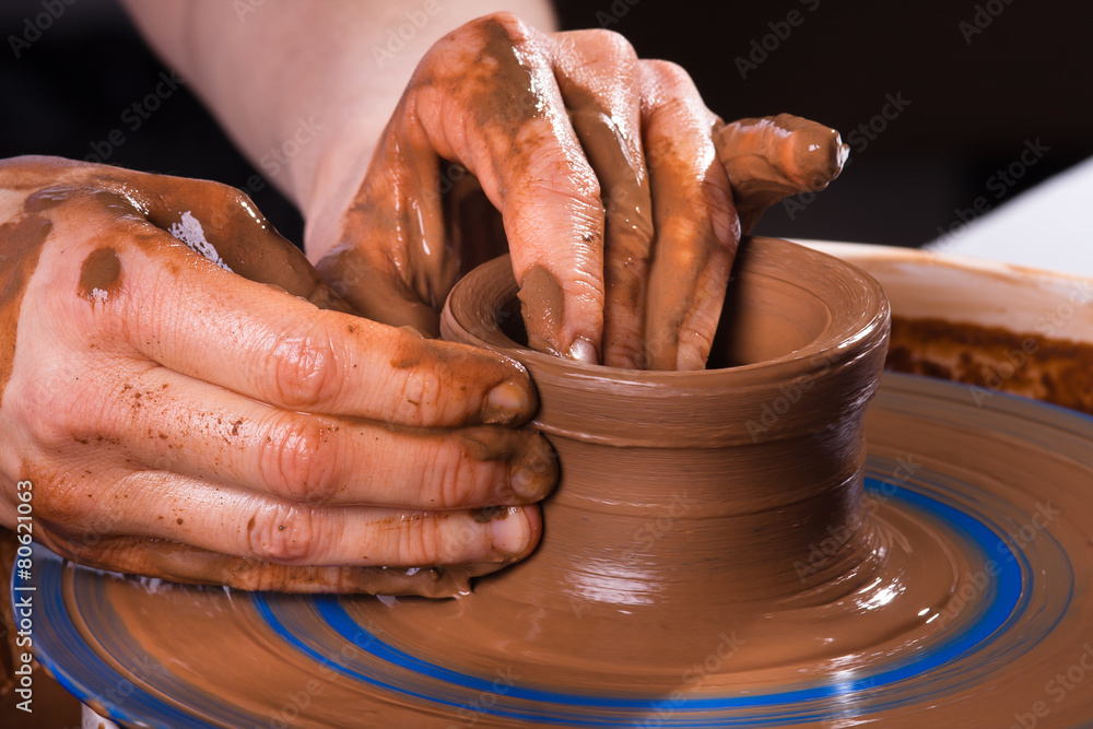 hands making clay pot