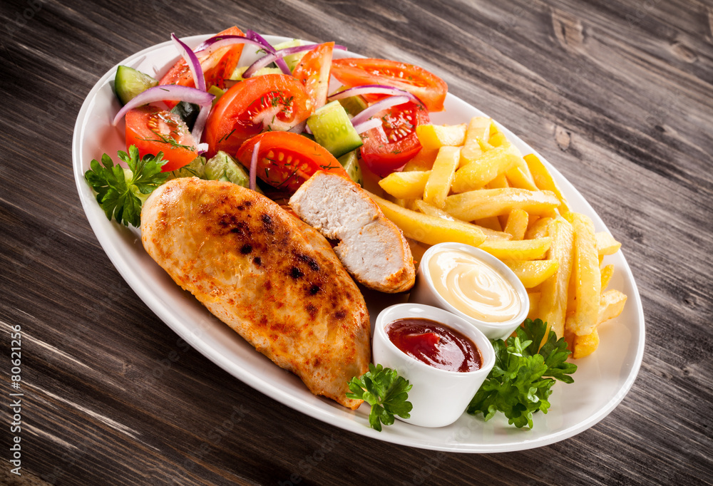 Fried chicken fillet, chips and vegetable salad Fried chicken fillet, chips and vegetable salad