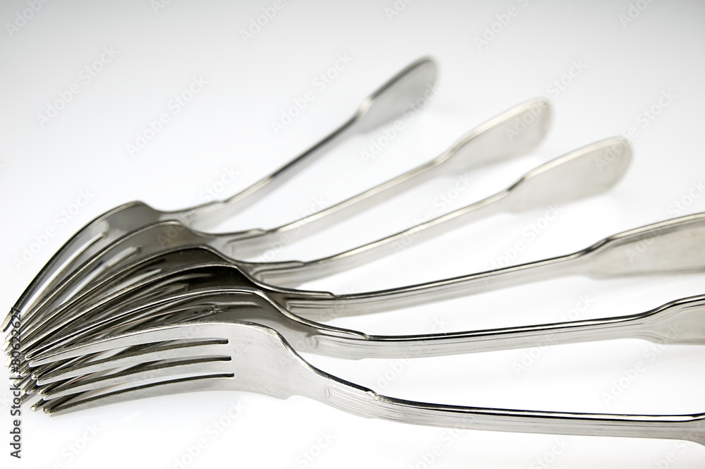 Forks arranged in series on the kitchen table. Forks arranged in series on the kitchen table.