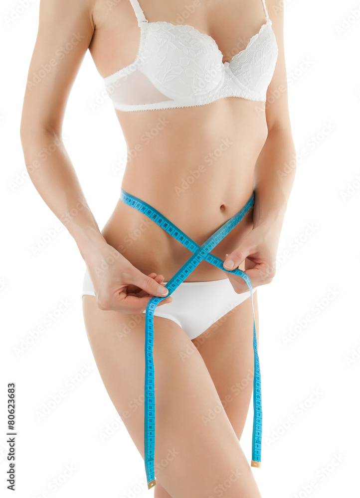 Woman measuring her slim body isolated on white background Woman measuring her slim body isolated on white background