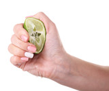 Female hand squeezing lime isolated on white