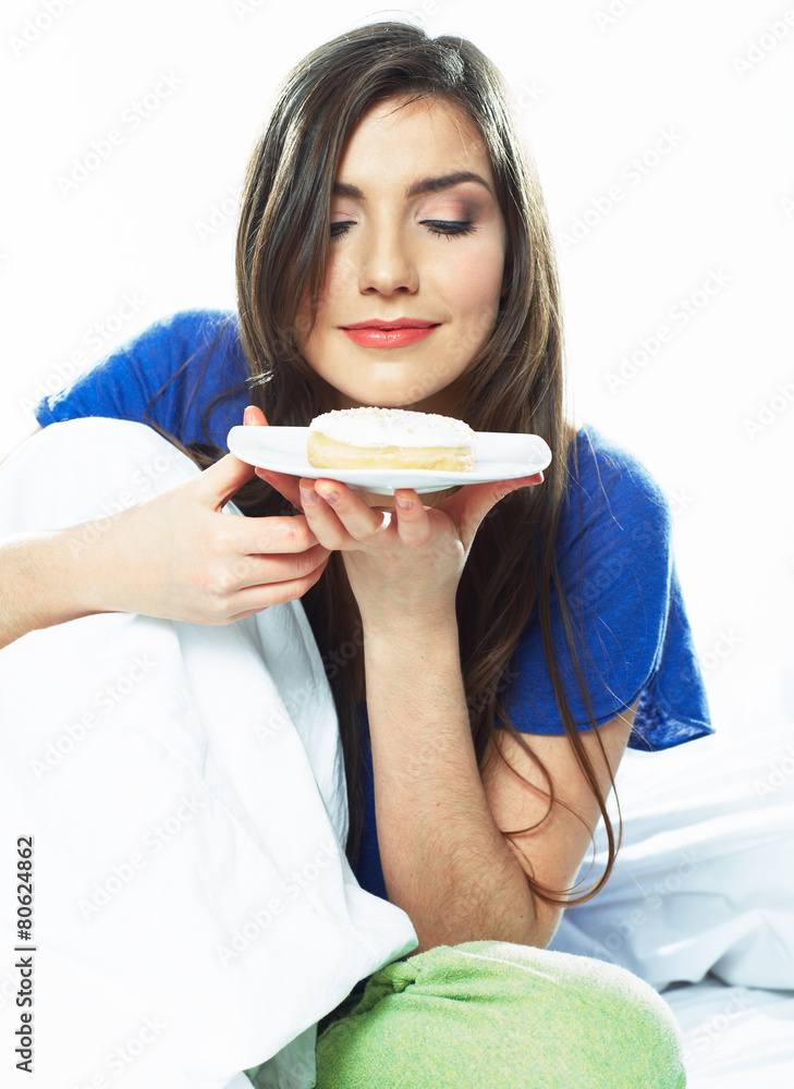 Woman eating donut. Young female model Woman eating donut. Young female model