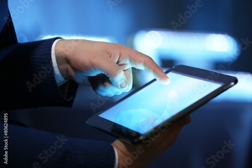 Male hand touching screen tablet close-up
