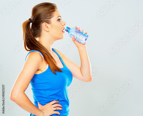 sporty woman drinking water of bottle