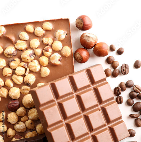 Chocolate bars with hazelnuts and coffee beans isolated on