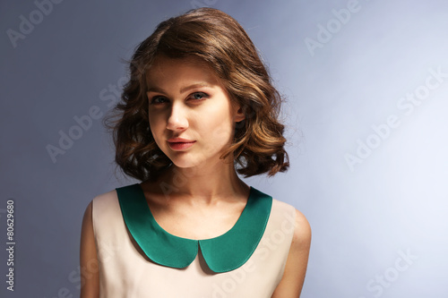 Portrait of beautiful model on gray background