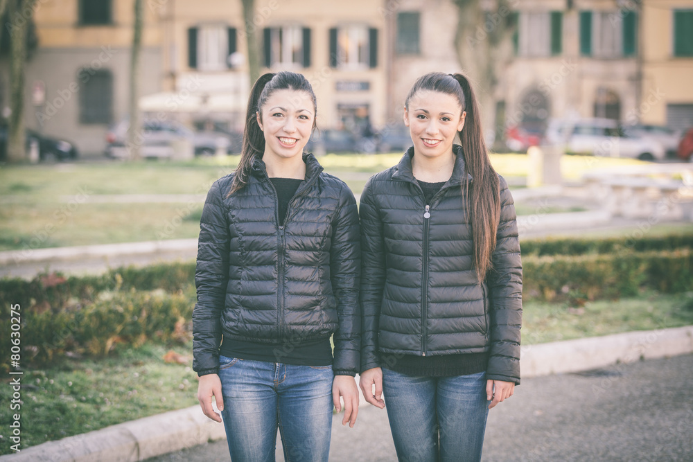Female twins portrait at park