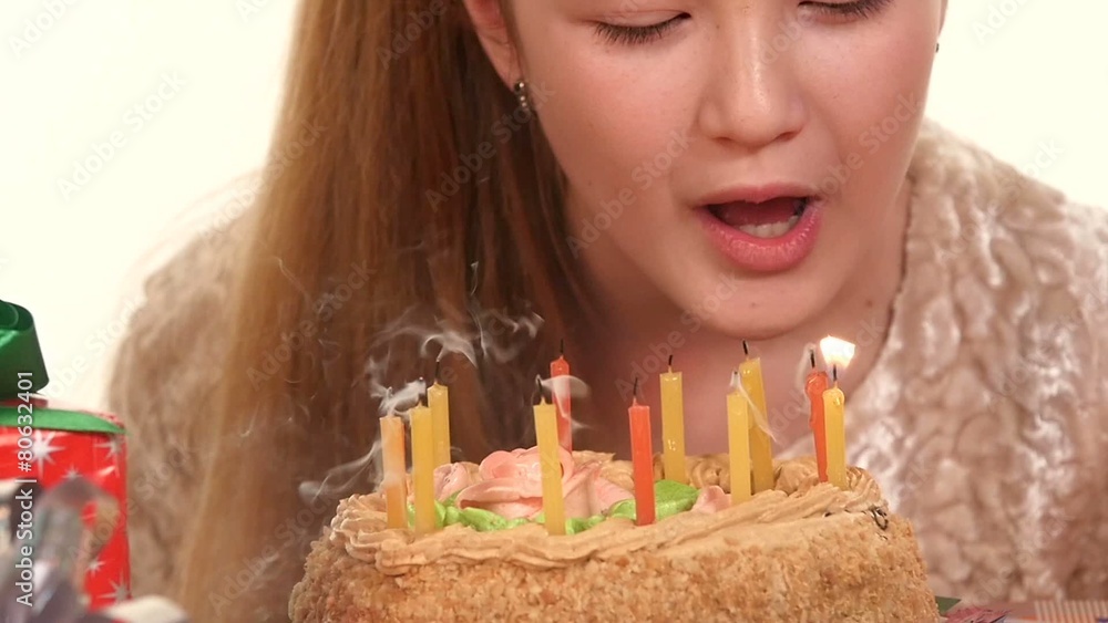 Girl decorate a birthday cake, cake scattered around gifts. The Girl decorate a birthday cake, cake scattered around gifts. The