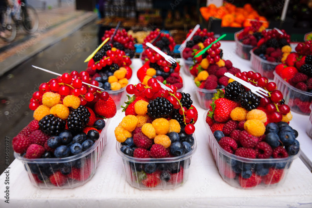 Sale of fresh berries. Focus on the foreground. Sale of fresh berries. Focus on the foreground.