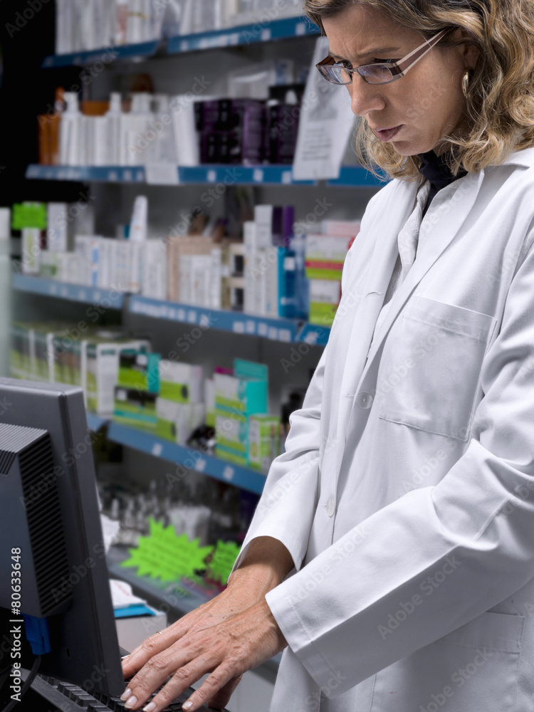 Women, pharmacy assistant, getting data into the computer