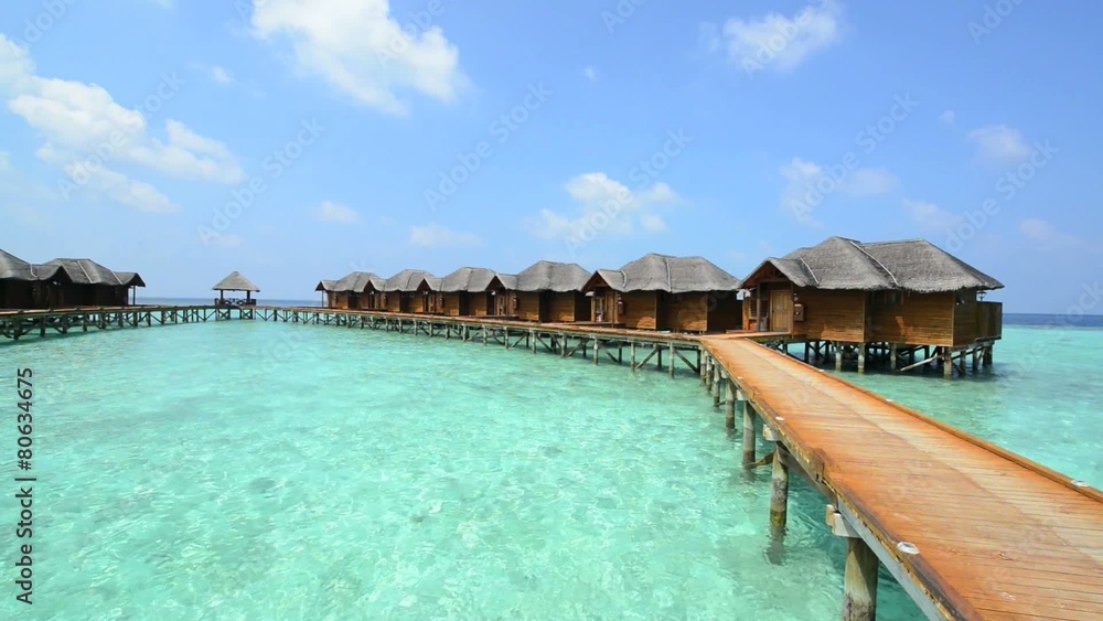 Over water bungalows with steps into amazing green lagoon Over water bungalows with steps into amazing green lagoon
