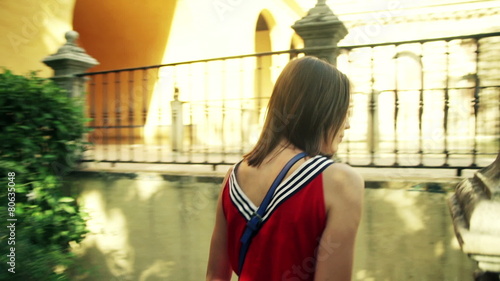 Young woman walking and admiring Alcazar garden in Seville