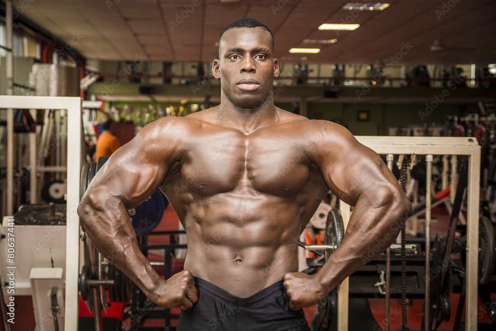 Handsome black male bodybuilder posing in gym Handsome black male bodybuilder posing in gym