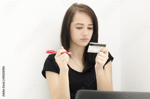 woman with pen and credit card