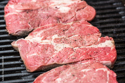 Fresh beef steaks on grill or BBQ