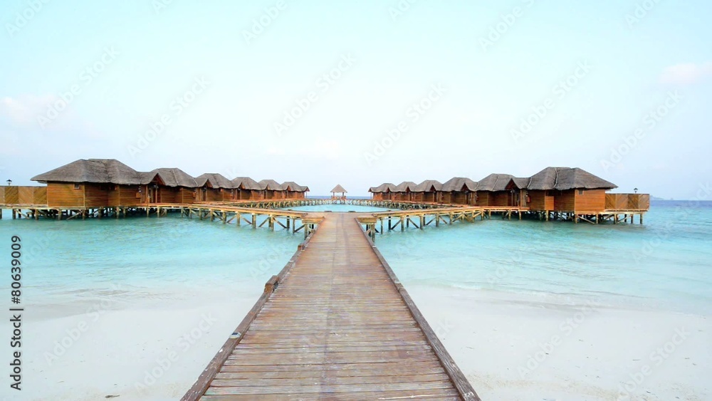 Over water bungalows with steps into amazing green lagoon Over water bungalows with steps into amazing green lagoon