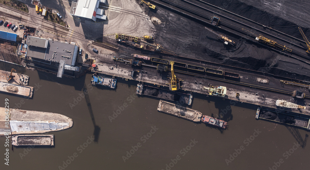 Fototapeta premium moving crane with a heap of coal next to the coal power plant in