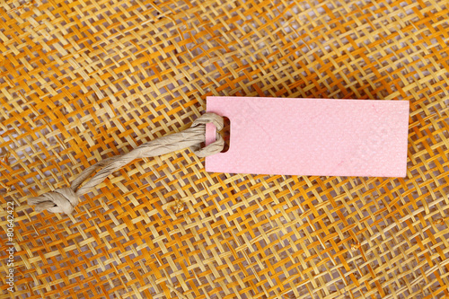 Paper tag blank for text on bamboo weave background.