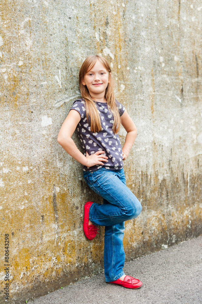 Outdoor portrait of a cute little girl wearing red moccasins Outdoor portrait of a cute little girl wearing red moccasins