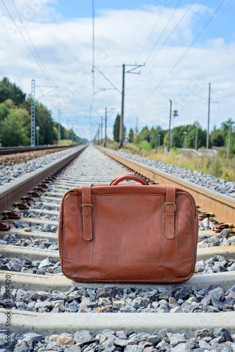 Vintage brown suitcase on the railway