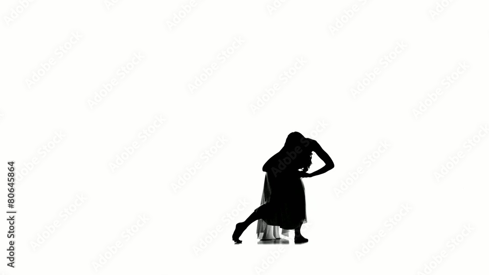 Slim, young woman dancer in long dress dancing on white Slim, young woman dancer in long dress dancing on white
