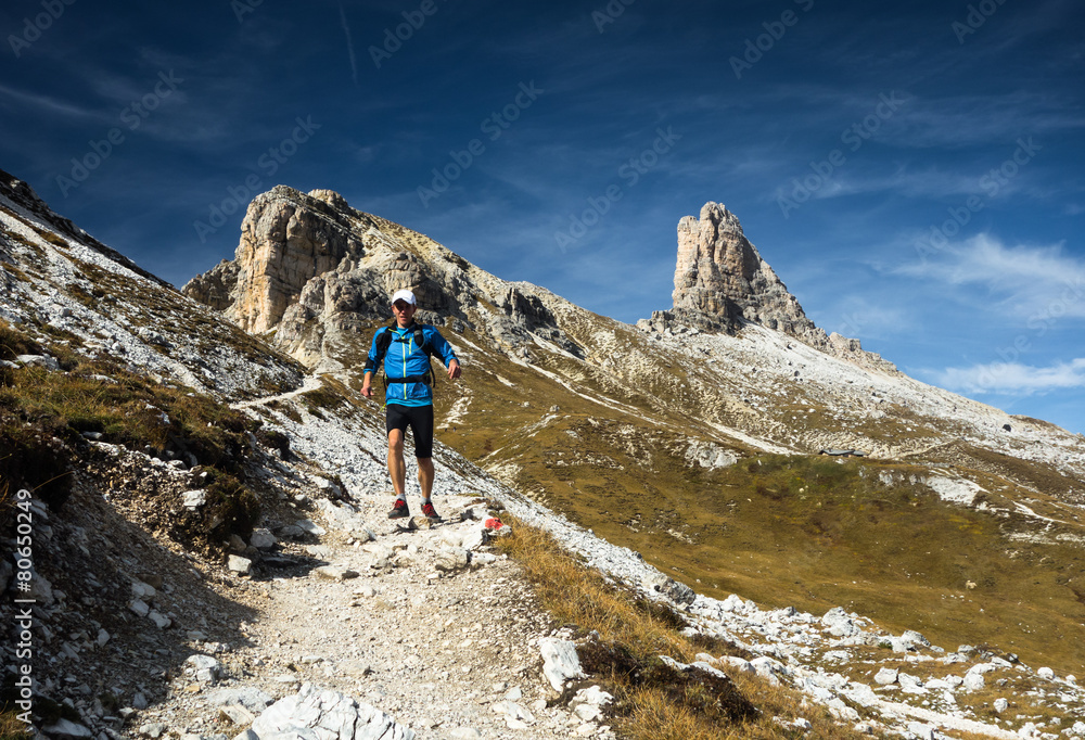 Man running downhill in Dolomites