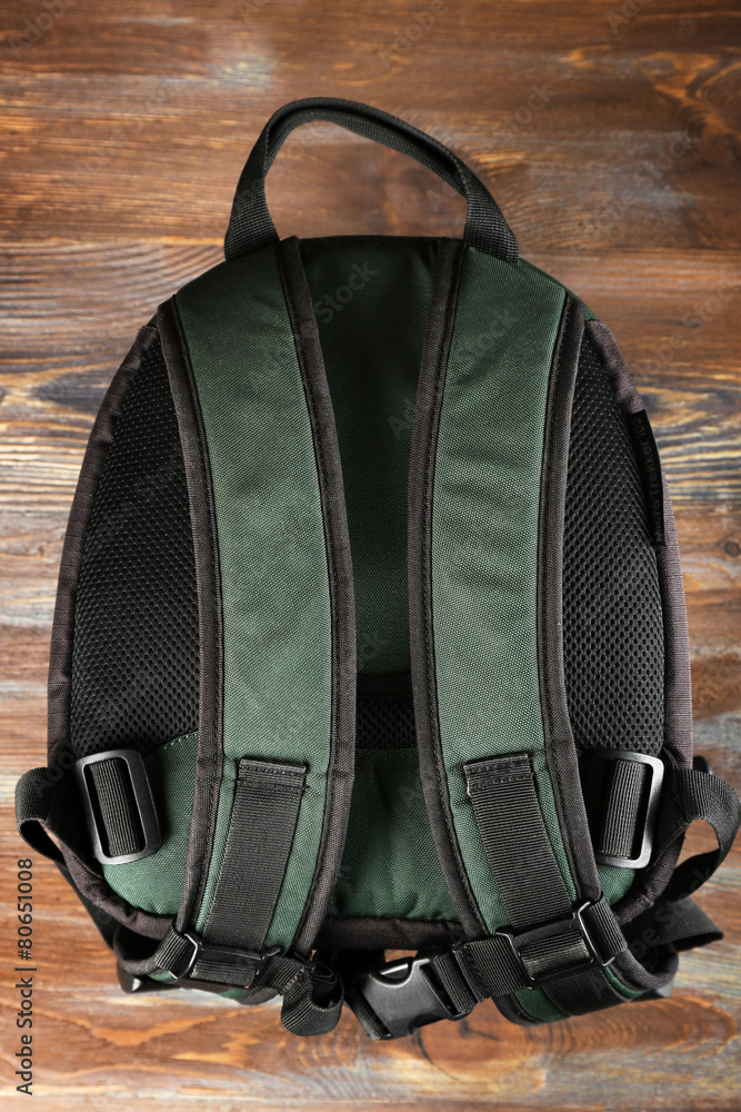 Naklejka premium Backpack on wooden background