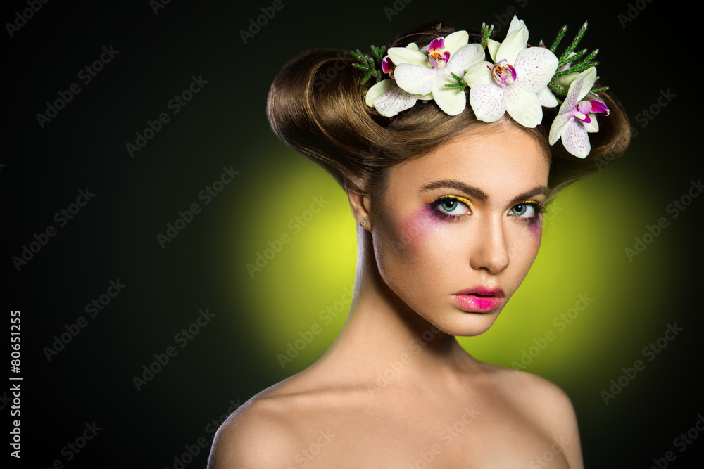Portrait of a beautiful woman with orchids flower in her hair.