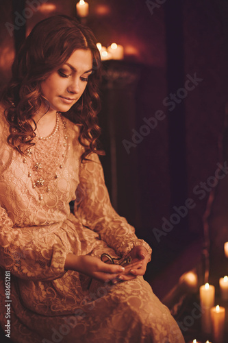 Portrait of beautiful young woman with candles