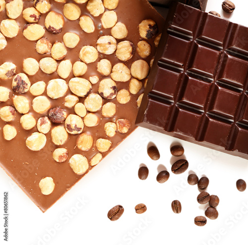 Chocolate bars with hazelnuts and coffee beans isolated on